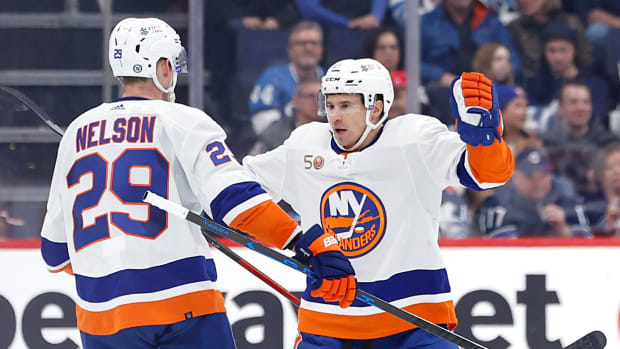 Feb 26, 2023; Winnipeg, Manitoba, CAN; New York Islanders center Brock Nelson (29) celebrates his second period goal with New York Islanders left wing Zach Parise (11) against the Winnipeg Jets at Canada Life Centre.